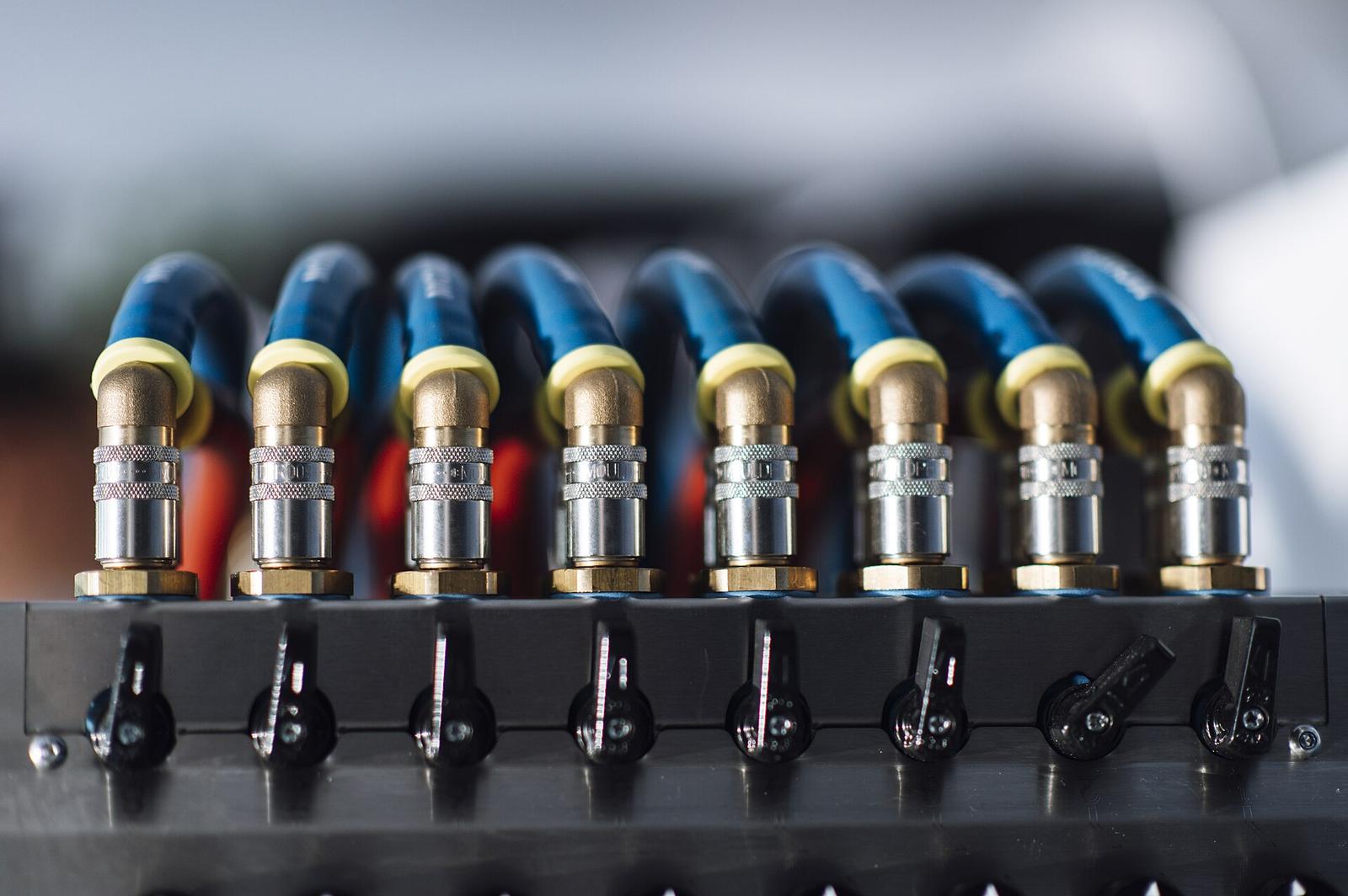A row of industrial air connectors on a machine
