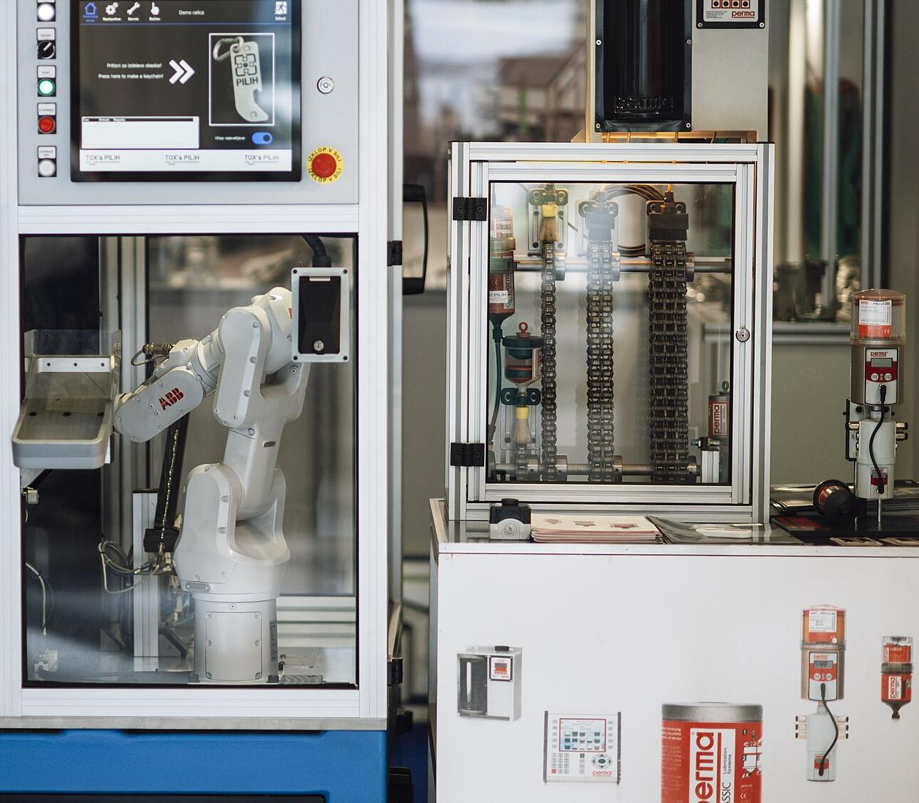 A robot arm working inside an automated machine cell